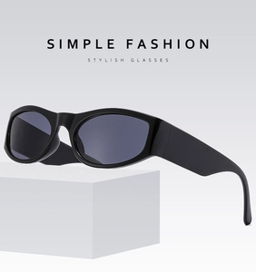 Side view of retro black sunglasses with wide temples and polished finish on white base