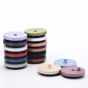 Close-up of colorful silicone cup lids with heart-shaped handles in various vibrant matte shades