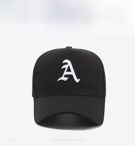 Close-up of gothic white embroidered letter A on a black cotton baseball cap surface