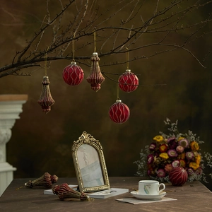 Vintage red glass Christmas ball and cone ornaments set hanging on winter branches