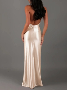 Detail of elegant backless design on champagne satin dress with lustrous fabric drape