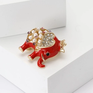 Detail of red enamel elephant brooch with pearls, rhinestones and golden alloy frame
