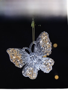 Detailed view of clear acrylic butterfly ornament with gold sequins and hanging string
