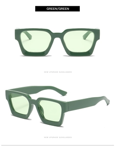 Detalle de gafas de sol cuadradas verdes modernas con lentes y montura verde a juego