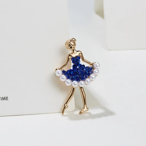 Detailed view of ballet dancer brooch with blue rhinestones and white pearls on gold alloy