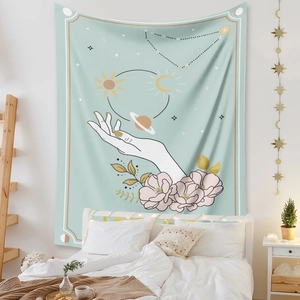 Detailed view of a mint green bohemian tapestry with sun and moon art in a bedroom setting