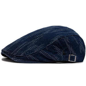 Vintage dark blue denim beret with white stitching and adjustable metal buckle