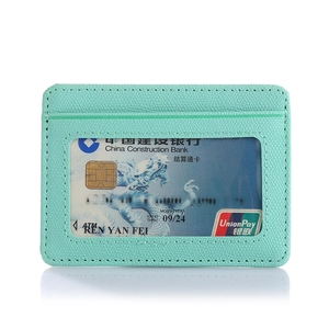 Detail of mint green lychee grain leather card holder with transparent window and neat stitching