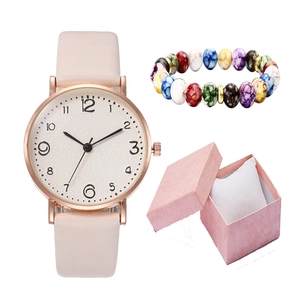 Pink leather watch and colorful beaded bracelet in a gift box with a white cushion