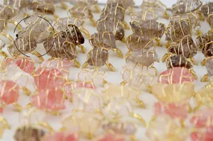 Detailed wire-wrapped natural crystal rings showing various raw gemstones and gold wire craft