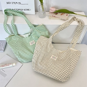 Polka dot canvas tote bags in mint green and beige with vintage labels and shoulder straps