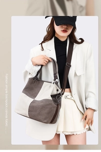 Detail of contrast canvas tote bag featuring adjustable strap and spacious shoulder design