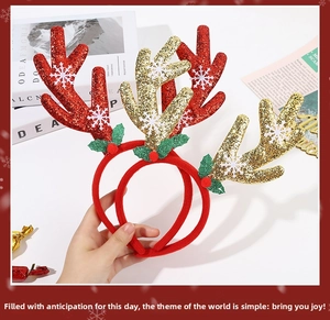 Detail of festive reindeer antler headbands with glitter, snowflakes, and holly berry decor