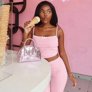 Pink ribbed knit two-piece set with a matching metallic faux-crocodile handbag for women
