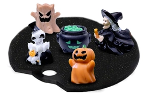 Close-up of Halloween resin miniature set featuring a ghost, skull, and witch figures