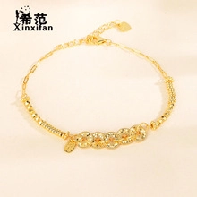 Detail shot of golden chunky chain bracelet with interlocking rings and heart charm