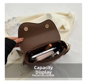 Detailed interior of vintage brown leather crossbody bag with dual magnetic closure