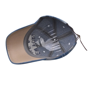 Detail view of denim baseball cap interior with leather strap and New York embroidery