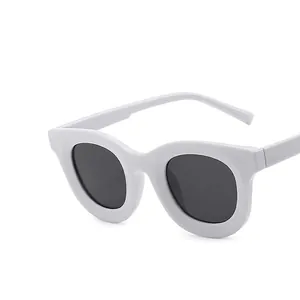Modern white thick frame round sunglasses with dark lenses and durable metal hinges
