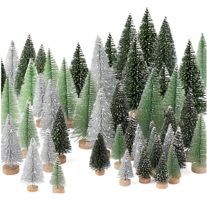 Assorted mini bottle brush Christmas trees in green and white on wooden bases