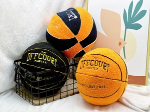 Detailed embroidery on colorful plush basketball pillows in an iron basket display