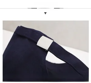 Detail of adjustable cotton strap and silver metal buckle on navy baseball cap