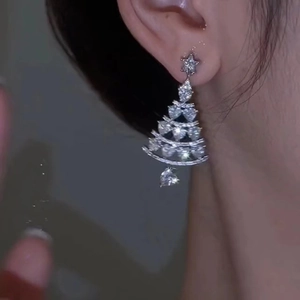 Sparkling silver Christmas tree drop earrings with cubic zirconia on female model