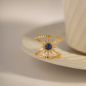 Double-layered gold titanium ring with blue lapis lazuli and radiant star pattern