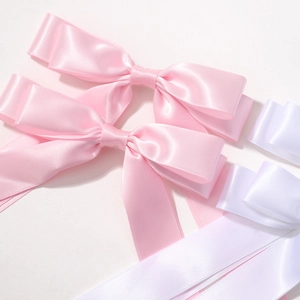 Double-layered satin ribbon bow hair clips in pink and white colors for girls