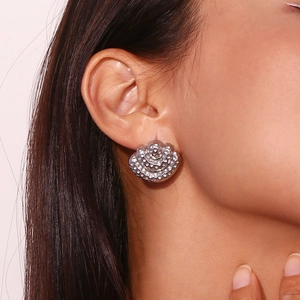 Three-layer hammered fan-shaped earrings in silver finish on model earlobes