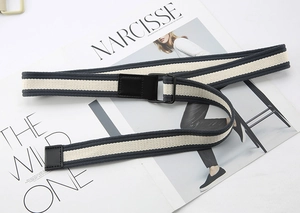 Detailed view of navy blue and beige striped canvas belt with black metal D-ring buckle