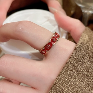 Detail of red enamel 14k gold plated ring with star engraving and cubic zirconia
