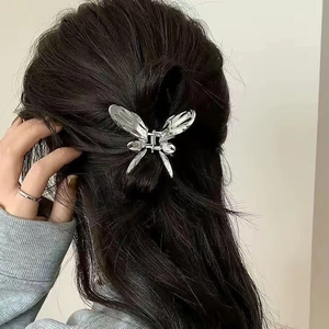 Silver liquid metal butterfly hair claw clip shown on dark hair for stylish back view styling