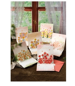Close-up of 3D pop-up floral greeting card with red rose design and elegant red envelope