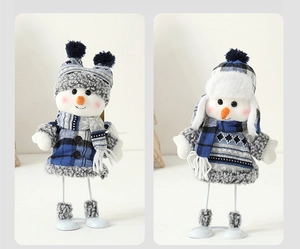Detail of plush snowmen dolls featuring blue plaid coats and retractable metal legs