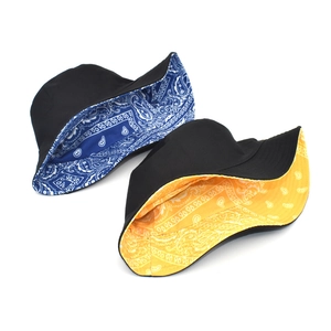 Double-sided paisley print cotton bucket hat with reversible black canvas sun protection