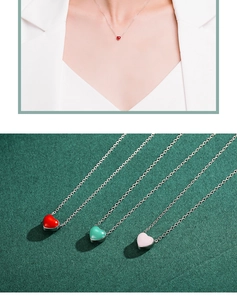Close-up of S925 silver heart necklaces in red, mint green, and pink enamel finishes