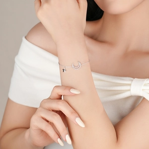 S925 sterling silver bracelet featuring sparkling moon and star pendants for women