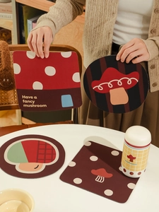 Close-up of cute mushroom diatom mud coasters and insulated water bottle on a warm table