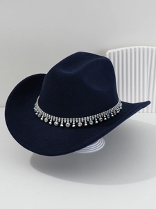 Detail of navy cowboy hat featuring silver chain trim and colorful rhinestone gemstones