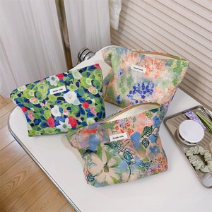 Detailed close-up of floral cotton cosmetic bags with zippers and simple wish labels