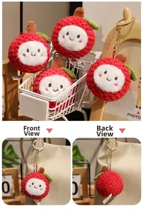 Close-up of plush lychee keychain with red textured fabric and cute embroidered face