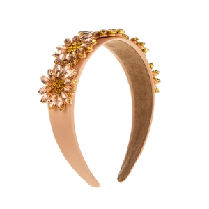 Macro detail of Baroque floral headband featuring champagne satin and crystal sunflower inlay