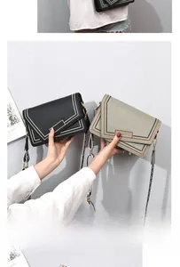 Detail of crossbody bag with wavy contrast stitching and patterned woven strap