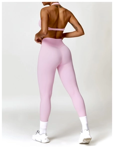 Rear view of pink cross-back sports bra and high-waisted leggings yoga set