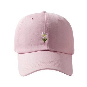 Pink cotton baseball cap featuring delicate daisy embroidery and a classic curved brim