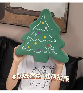 Detail of soft green Christmas tree plush pillow with colorful embroidered dots decoration