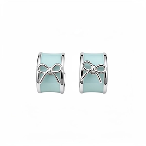 Elegant silver C-shaped hoop earrings with light blue enamel and small bow accents