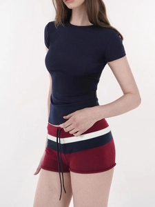 Detail of slim fit navy blue short sleeve sports top and striped drawstring shorts set