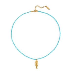 Detailed macro view of ocean-style turquoise beaded necklace with golden fish pendant